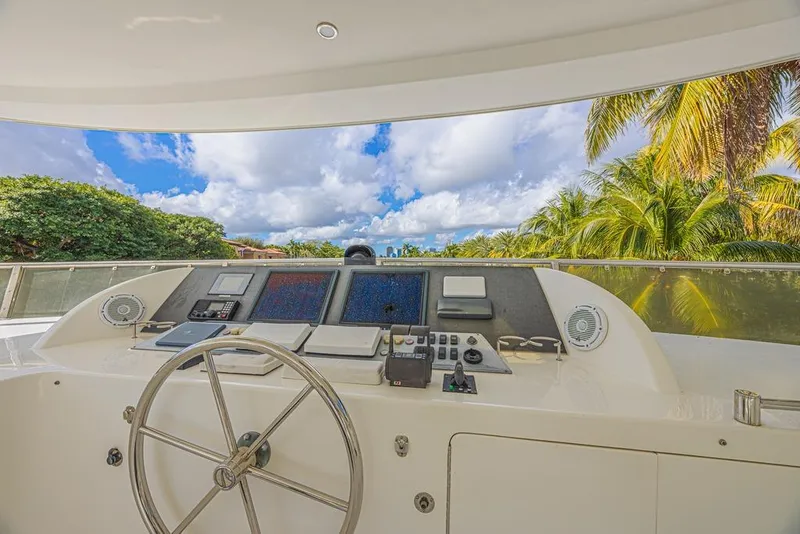 Slide: The Image of Cockpit view of 2010 Ocean Alexander 74 Motoryacht with lush tropical backdrop. - 15