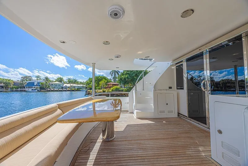 Slide: The Image of Luxurious 2010 Ocean Alexander 74 Motoryacht deck with seating and scenic waterfront view. - 11