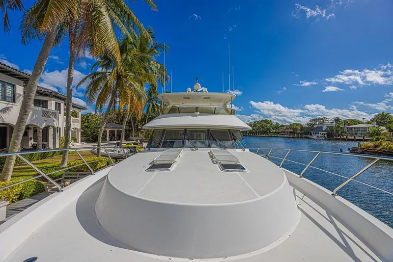 Slide: The Image of 2010 Ocean Alexander 74 Motoryacht docked by palm trees and waterfront homes. - 10