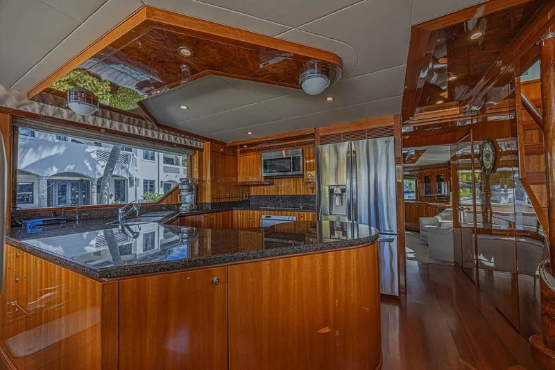 Slide: The Image of Luxurious kitchen interior of 2010 Ocean Alexander 74 Motoryacht with wood finishes and modern appliances. - 34
