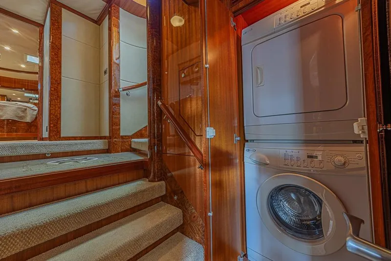 Slide: The Image of Laundry area inside 2010 Ocean Alexander 74 Motoryacht, featuring stacked washer and dryer. - 54