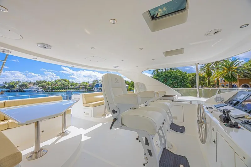Slide: The Image of Luxurious 2010 Ocean Alexander 74 Motoryacht helm with plush seating and scenic waterfront view. - 16