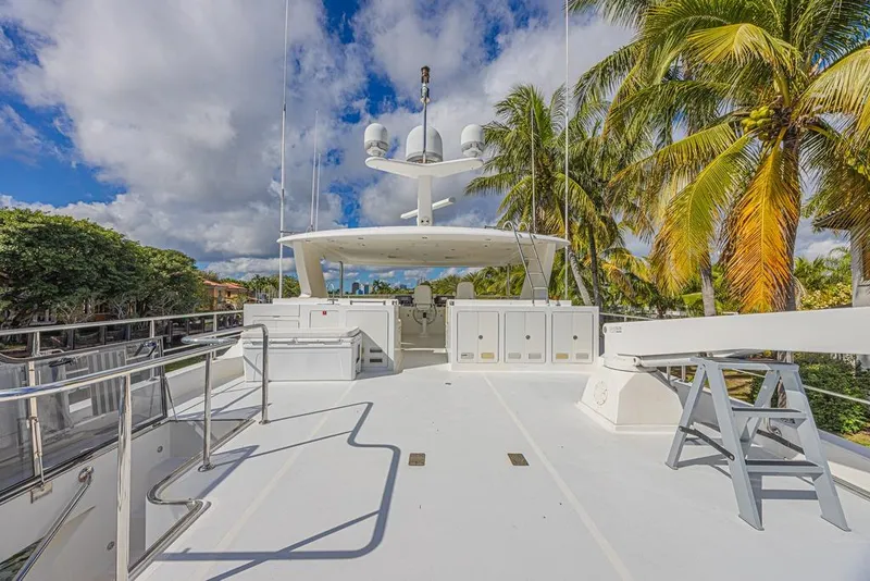 Slide: The Image of 2010 Ocean Alexander 74 Motoryacht deck with palm trees and blue sky background. - 21