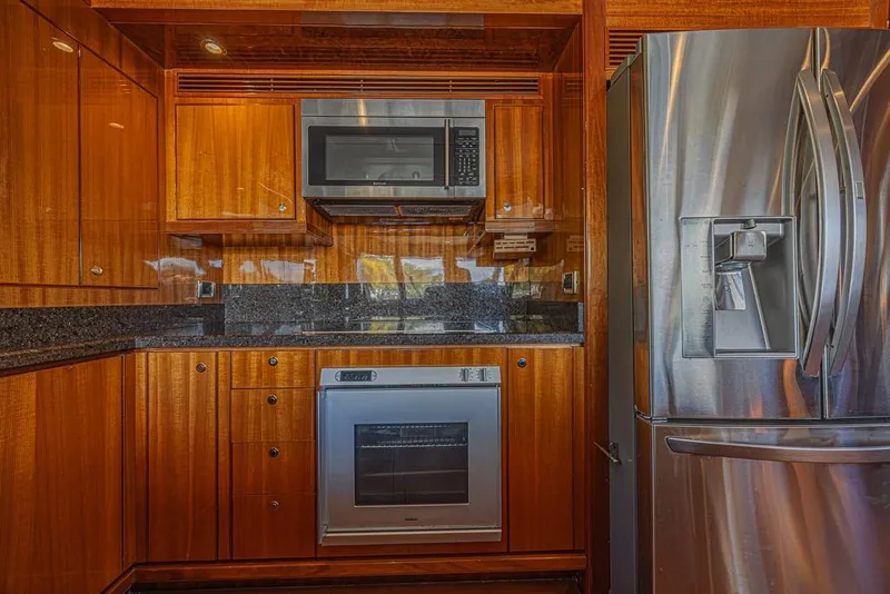 Slide: The Image of Luxurious kitchen in 2010 Ocean Alexander 74 Motoryacht with stainless steel appliances and wood cabinetry. - 32