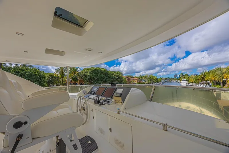 Slide: The Image of Luxurious helm of 2010 Ocean Alexander 74 Motoryacht with scenic waterfront view. - 14