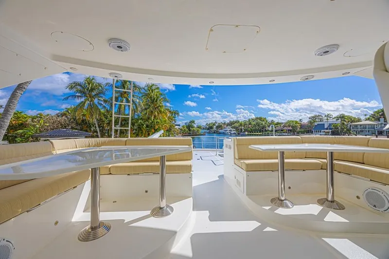Slide: The Image of Luxurious 2010 Ocean Alexander 74 Motoryacht deck with seating, overlooking serene waterfront. - 17