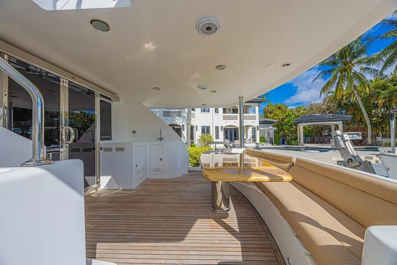 Slide: The Image of Luxurious 2010 Ocean Alexander 74 Motoryacht deck with seating and table, tropical backdrop. - 23