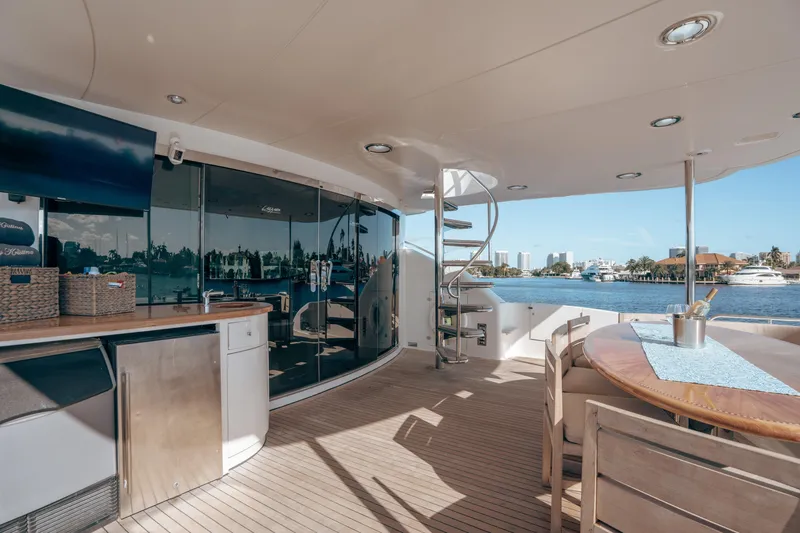 Slide: The Image of Luxurious 2004 Lazzara 106 yacht deck with spiral staircase and waterfront view. - 28