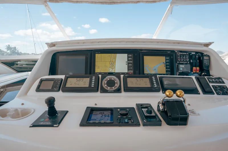 Slide: The Image of Control panel of a 2004 Lazzara 106 yacht with navigation and throttle controls. - 22