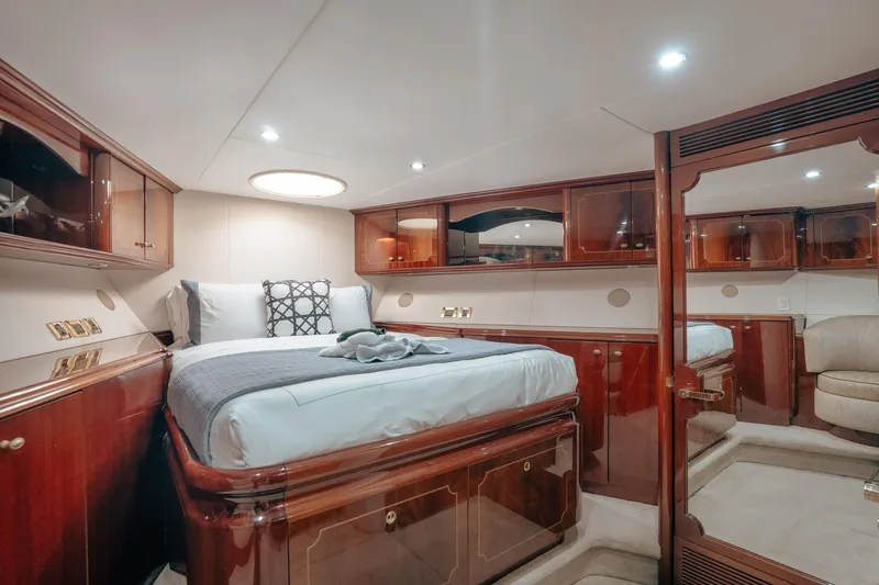 Slide: The Image of Luxurious bedroom interior of 2004 Lazzara 106 yacht with elegant wood finishes and cozy bedding. - 52