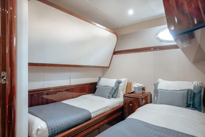 Slide: The Image of Luxurious twin cabin interior on 2004 Lazzara 106 yacht, featuring elegant wood finishes. - 39