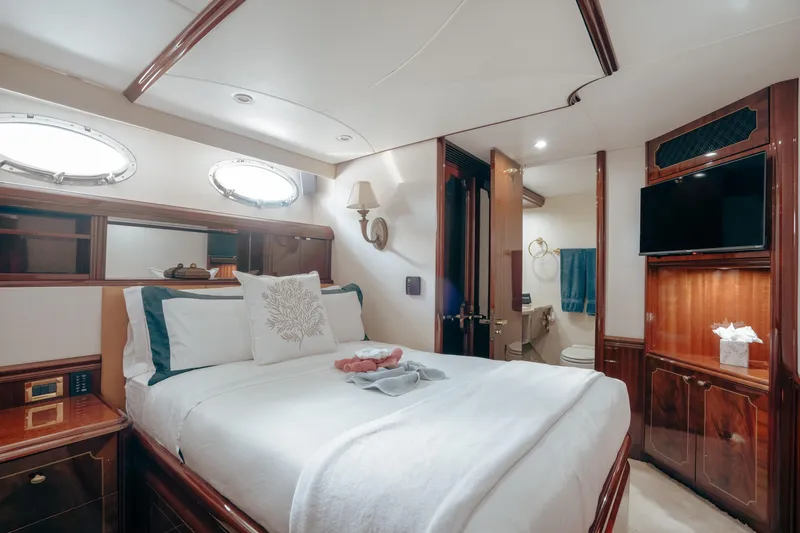Slide: The Image of Luxurious bedroom interior of 2004 Lazzara 106 yacht with elegant wood finishes and modern amenities. - 34