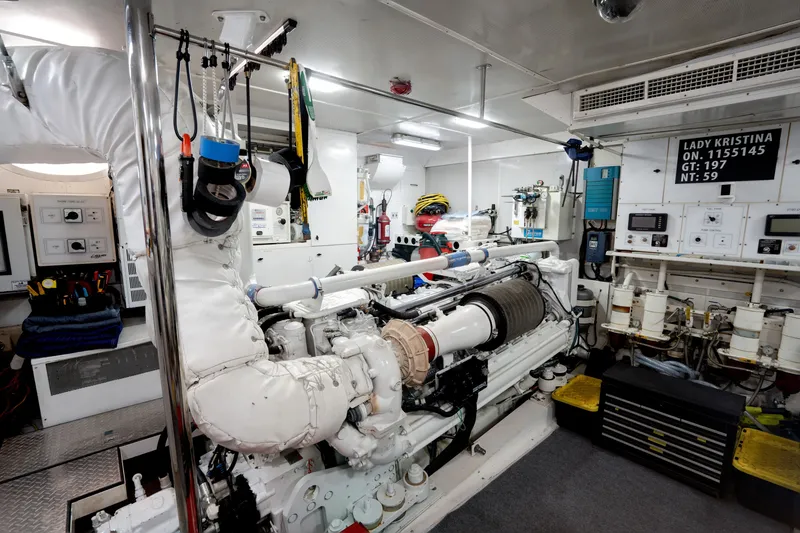 Slide: The Image of Engine room of 2004 Lazzara 106 yacht, featuring machinery and control panels. - 69
