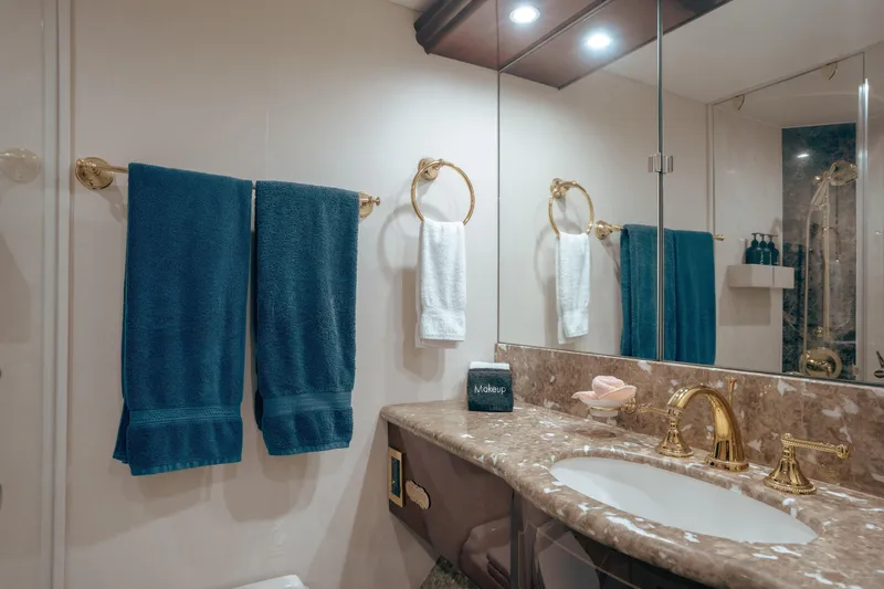 Slide: The Image of Luxurious bathroom in 2004 Lazzara 106 yacht with marble countertop and gold fixtures. - 58