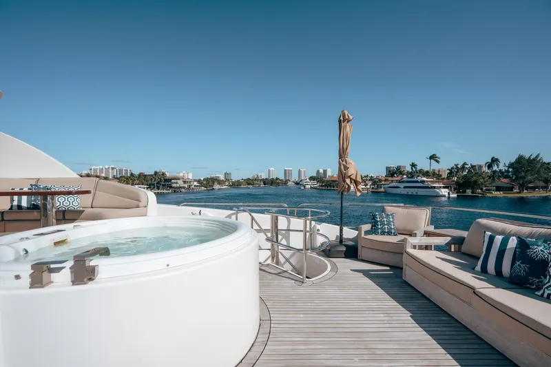 Slide: The Image of Luxurious 2004 Lazzara 106 yacht deck with hot tub and seating, overlooking waterfront. - 9