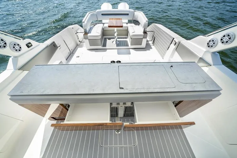 Slide: The Image of Manufacturer Provided Image: 2025 Tiara Yachts 43 LS luxury boat interior with seating and table on water. - 19