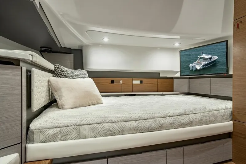 Slide: The Image of Manufacturer Provided Image: Luxurious interior cabin of 2025 Tiara Yachts 43 LS with modern bedding and TV. - 27