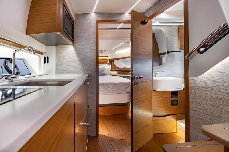 Slide: The Image of Manufacturer Provided Image: Luxurious interior of 2026 Tiara Yachts 39 LE, featuring modern kitchen and cozy bedroom. - 14