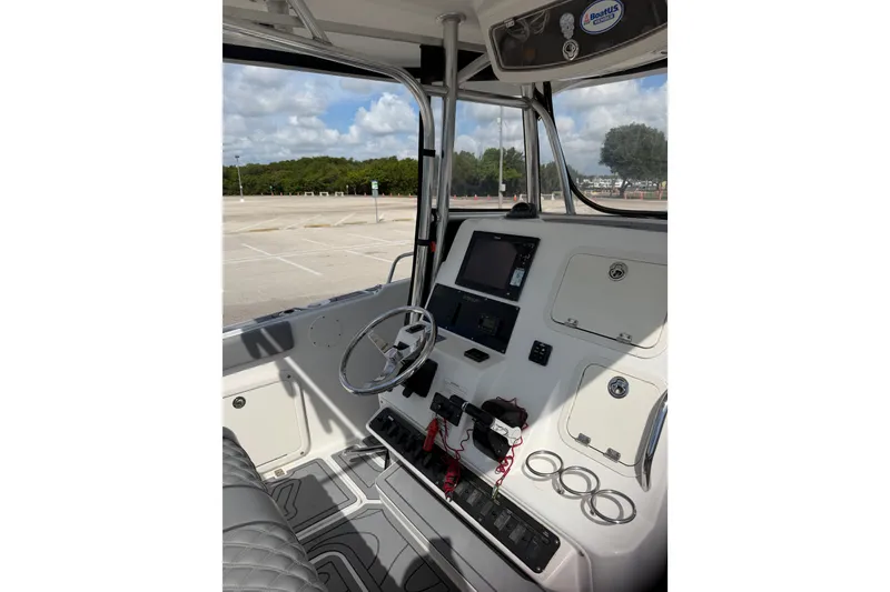 Slide: The Image of Interior view of 2006 Century 3200 Center Console boat with steering wheel and control panel. - 6