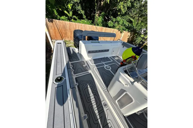 Slide: The Image of 2006 Century 3200 Center Console boat with sleek deck design and fishing gear. - 9