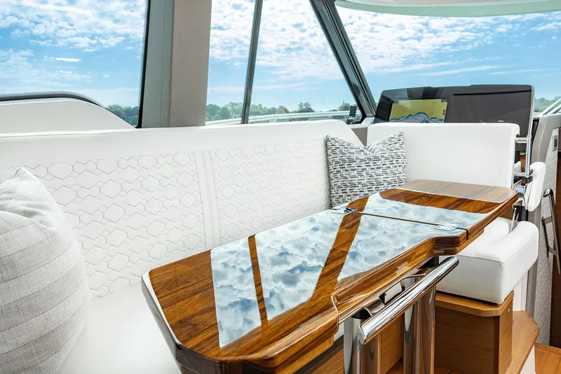 Slide: The Image of Manufacturer Provided Image: Luxurious interior of 2025 Tiara Yachts 43 LE with elegant seating and wooden table. - 13