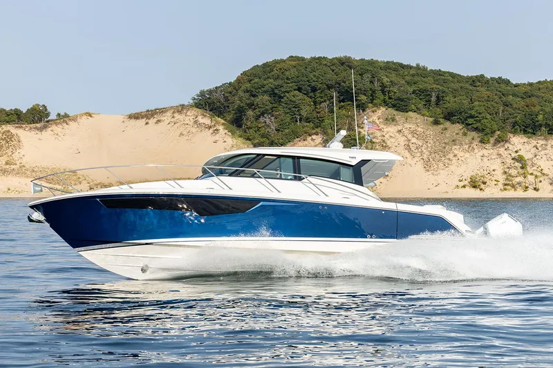 The Image of Manufacturer Provided Image: 2025 Tiara Yachts 43 LE cruising on water near sandy dunes. - 0