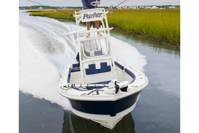 The Image of Manufacturer Provided Image: Parker 220 Coastal Elite 2027 boat cruising through serene waters with lush green surroundings. - 1