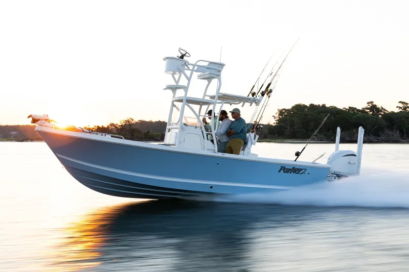 The Image of Manufacturer Provided Image: 2027 Parker 240 Coastal Elite boat cruising at sunset with fishing gear. - 0