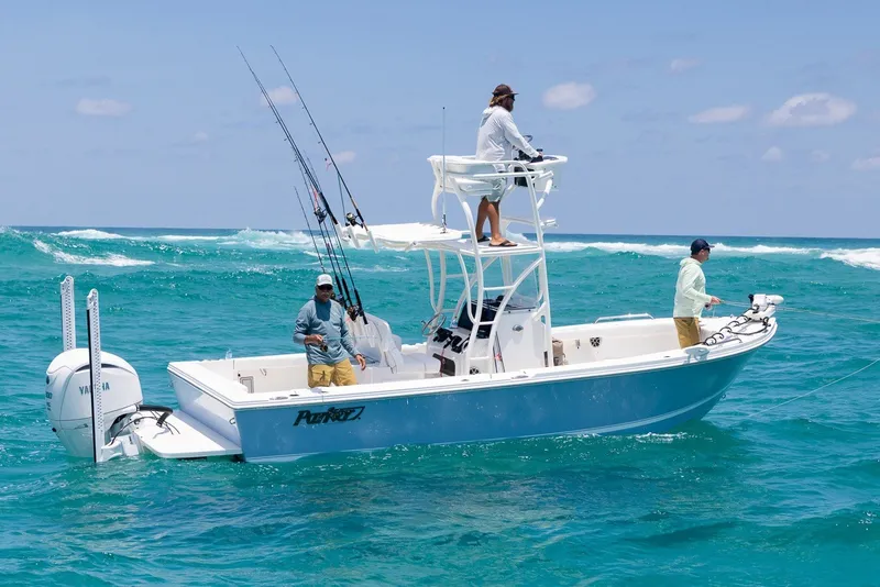 Slide: The Image of Manufacturer Provided Image: 2027 Parker 240 Coastal Elite boat with anglers on turquoise ocean waters. - 2