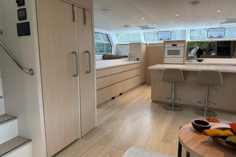 Slide: The Image of Modern kitchen interior of 2023 Longreach 58 Expedition yacht with sleek cabinetry and bar stools. - 52