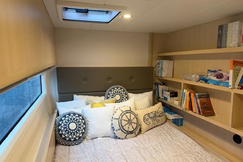 Slide: The Image of Cozy cabin interior of 2023 Longreach 58 Expedition yacht with decorative pillows and bookshelves. - 72