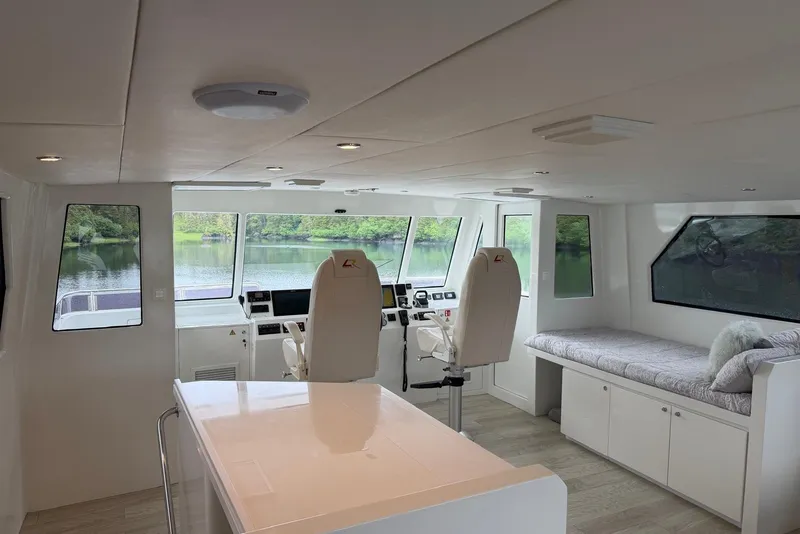 Slide: The Image of Interior of 2023 Longreach 58 Expedition yacht with helm, seating, and large windows. - 21