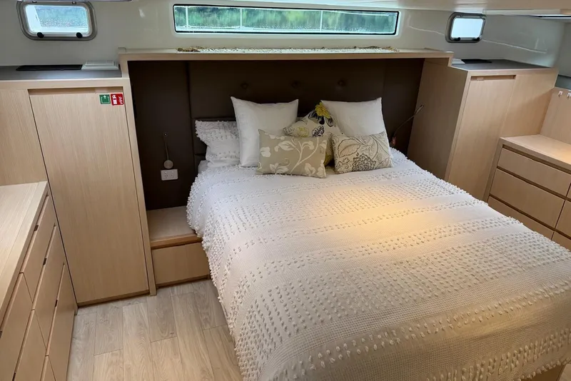 Slide: The Image of Luxurious bedroom interior of 2023 Longreach 58 Expedition yacht with elegant bedding and wood cabinetry. - 63