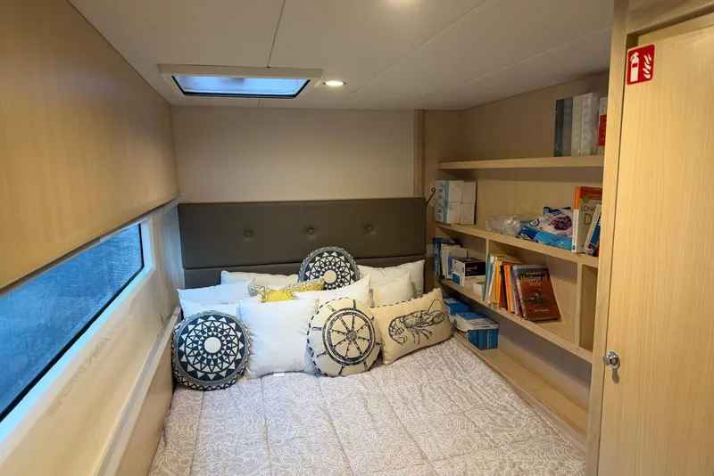 Slide: The Image of Cozy cabin interior of 2023 Longreach 58 Expedition yacht with bed, pillows, and bookshelves. - 75