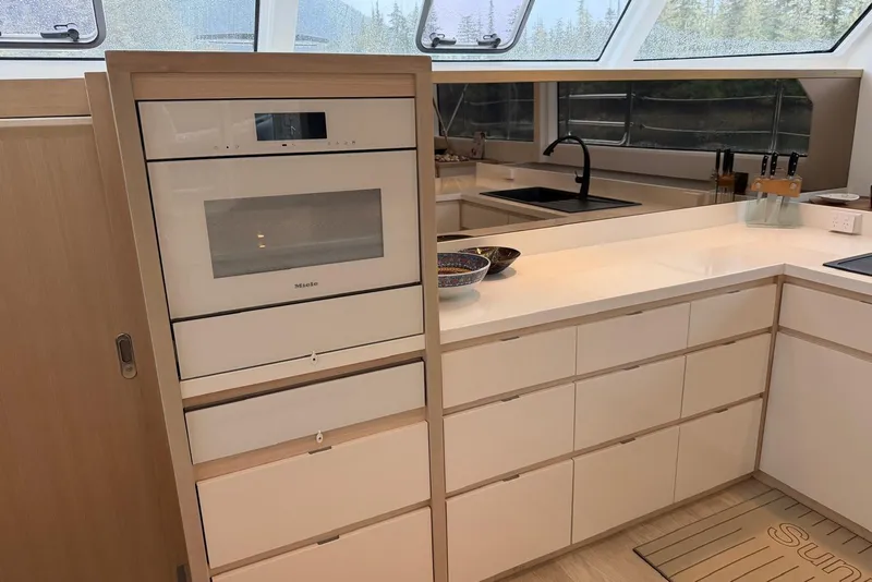 Slide: The Image of Modern kitchen in 2023 Longreach 58 Expedition yacht with sleek cabinetry and built-in oven. - 49