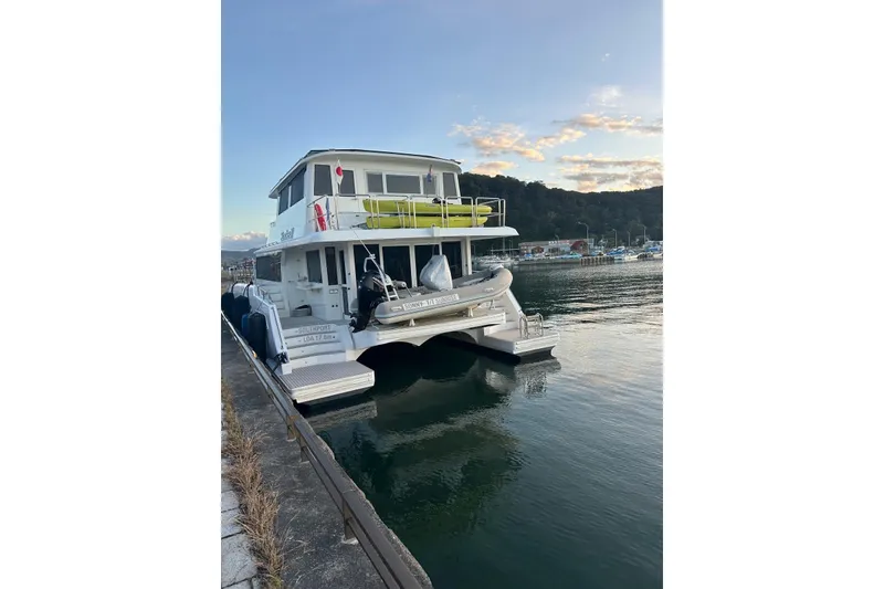 Slide: The Image of 2023 Longreach 58 catamaran docked at a marina during sunset. - 7