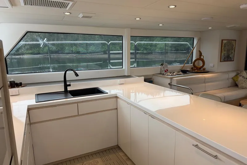 Slide: The Image of Luxurious interior of 2023 Longreach 58 Expedition yacht with modern kitchen and scenic window view. - 43