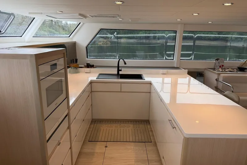 Slide: The Image of Modern kitchen interior of 2023 Longreach 58 Expedition yacht with sleek countertops and large windows. - 48