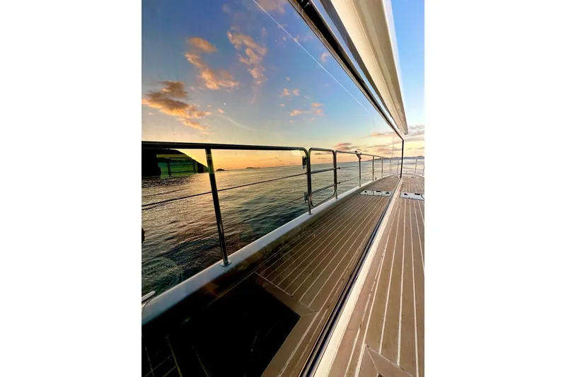 Slide: The Image of Longreach 58 yacht deck reflecting sunset over calm ocean, 2023 model. - 10