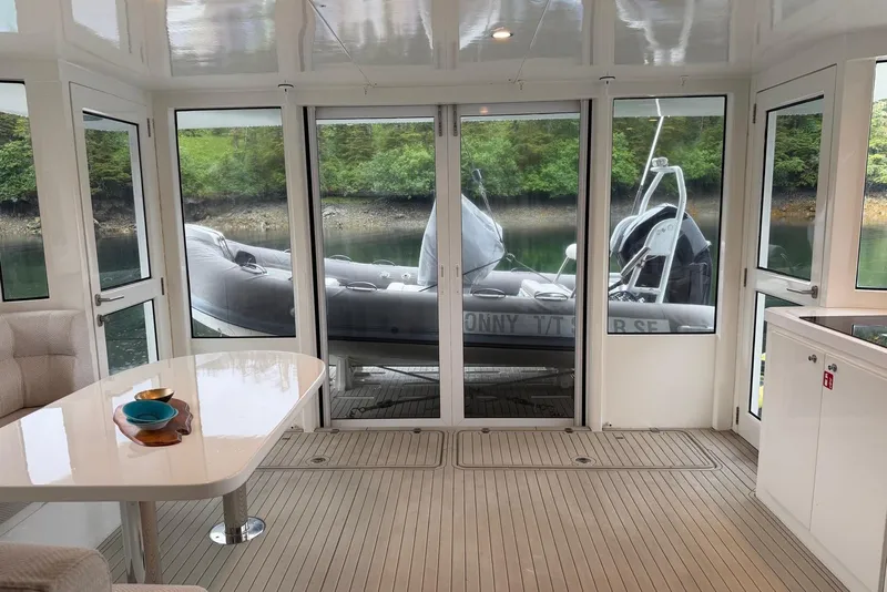 Slide: The Image of Interior of 2023 Longreach 58 Expedition yacht with scenic water view through glass doors. - 19