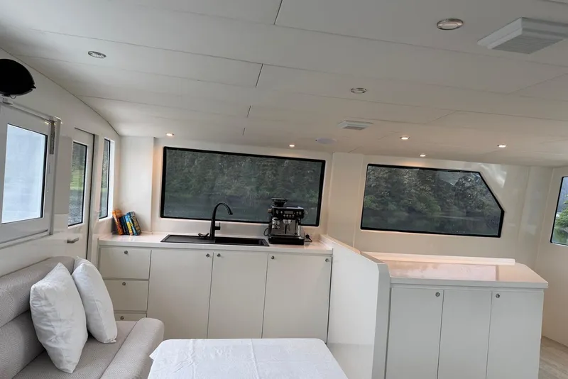 Slide: The Image of Modern interior of 2023 Longreach 58 Expedition yacht with sleek kitchen and large windows. - 28