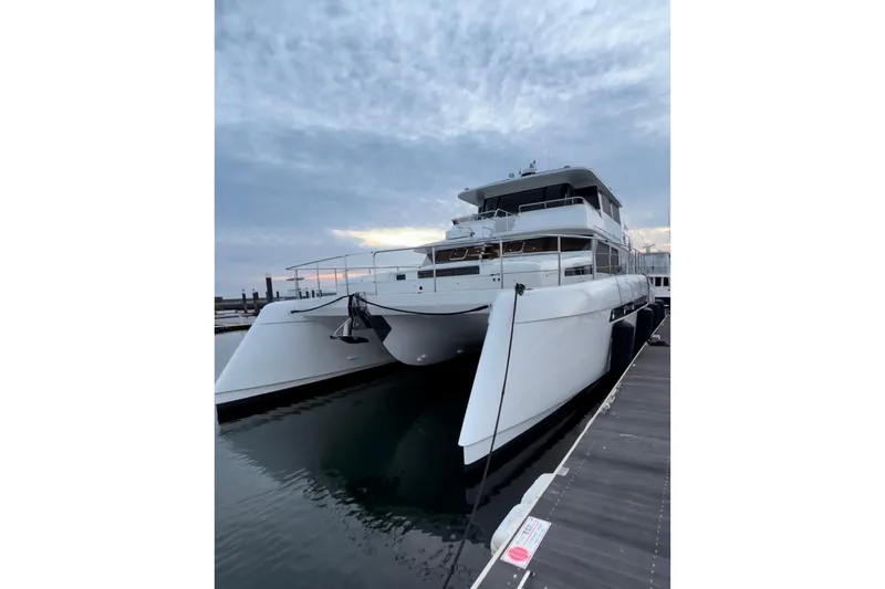 Slide: The Image of 2023 Longreach 58 catamaran docked at marina during sunset. - 6