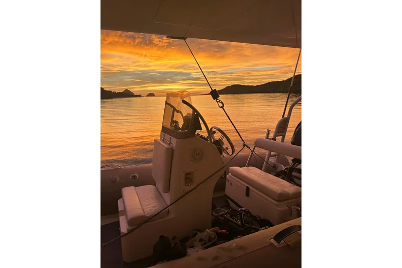 Slide: The Image of Longreach 58 boat interior at sunset, 2023 model, with scenic ocean view. - 12