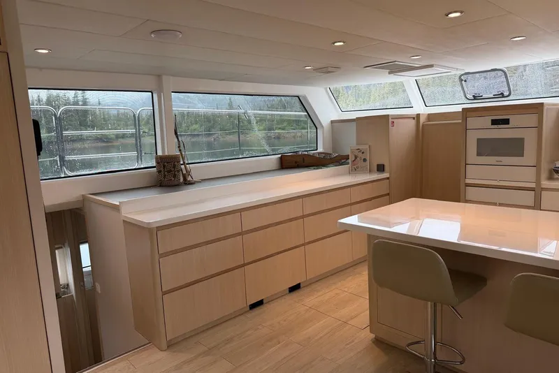 Slide: The Image of Luxurious interior of 2023 Longreach 58 Expedition yacht with modern kitchen and panoramic windows. - 42