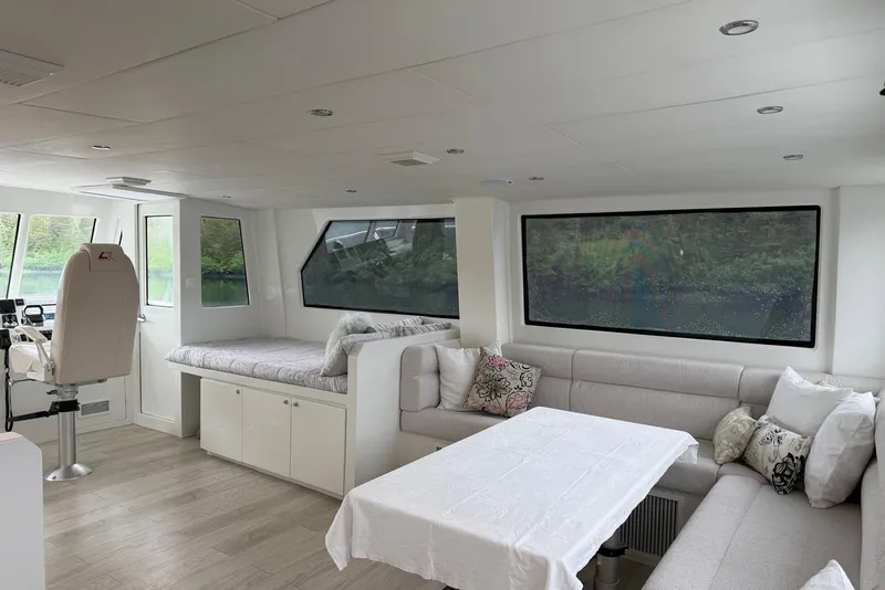Slide: The Image of Luxurious interior of 2023 Longreach 58 Expedition yacht with modern seating and large windows. - 26