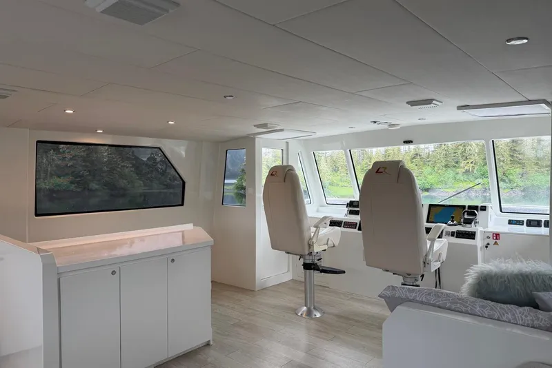 Slide: The Image of Interior of 2023 Longreach 58 Expedition yacht with modern helm and panoramic windows. - 23