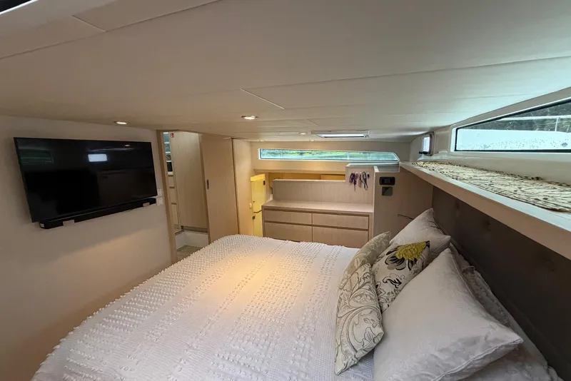Slide: The Image of Luxurious bedroom interior of 2023 Longreach 58 Expedition yacht with TV and elegant bedding. - 55