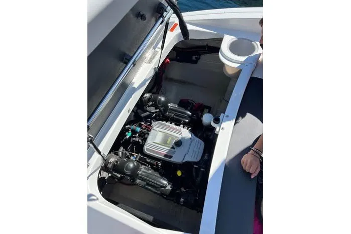 Slide: The Image of Engine compartment of a 2017 Rinker QX23 CC boat, showcasing internal components. - 26