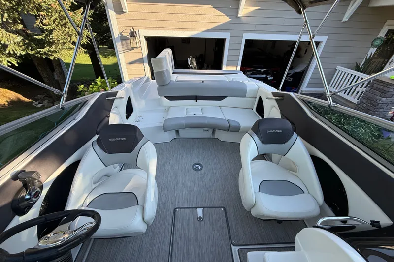 Slide: The Image of 2017 Rinker QX23 CC boat interior with white seating and modern design. - 14