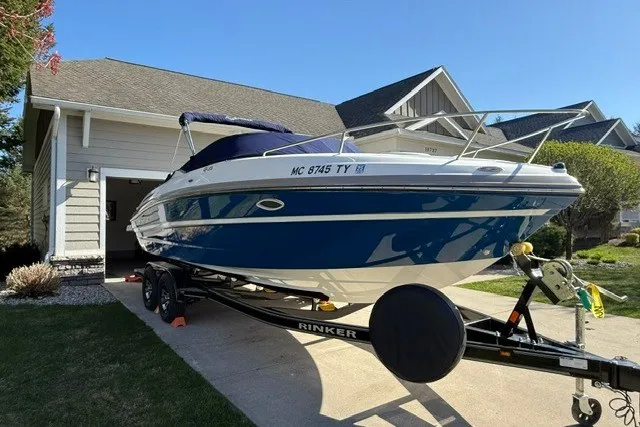 Slide: The Image of 2017 Rinker QX23 CC boat on trailer in residential driveway. - 8